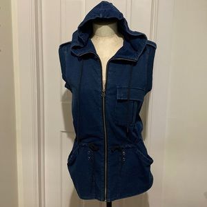 Indigo dyed utility style sleeveless hoodie; black drawcords silver rivet detail